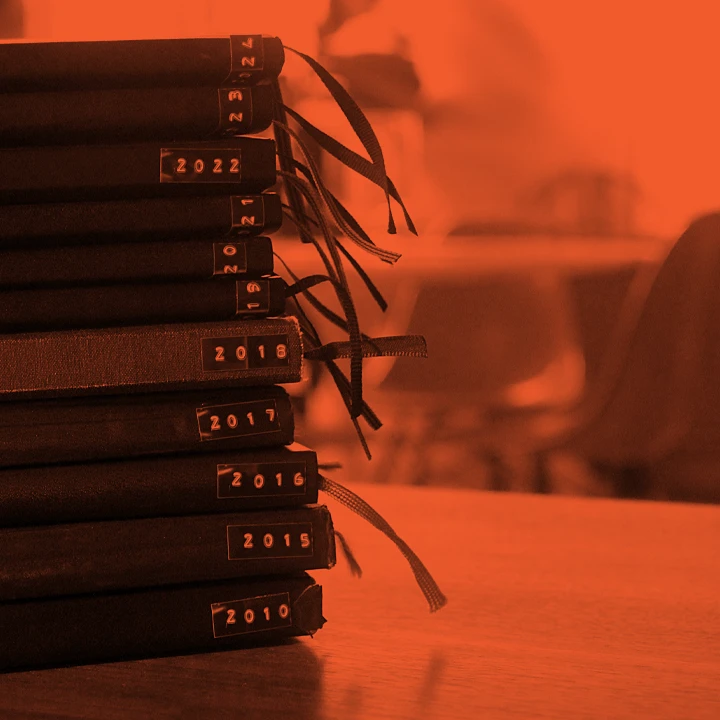A stack of sketchbooks from 2010 to 2024